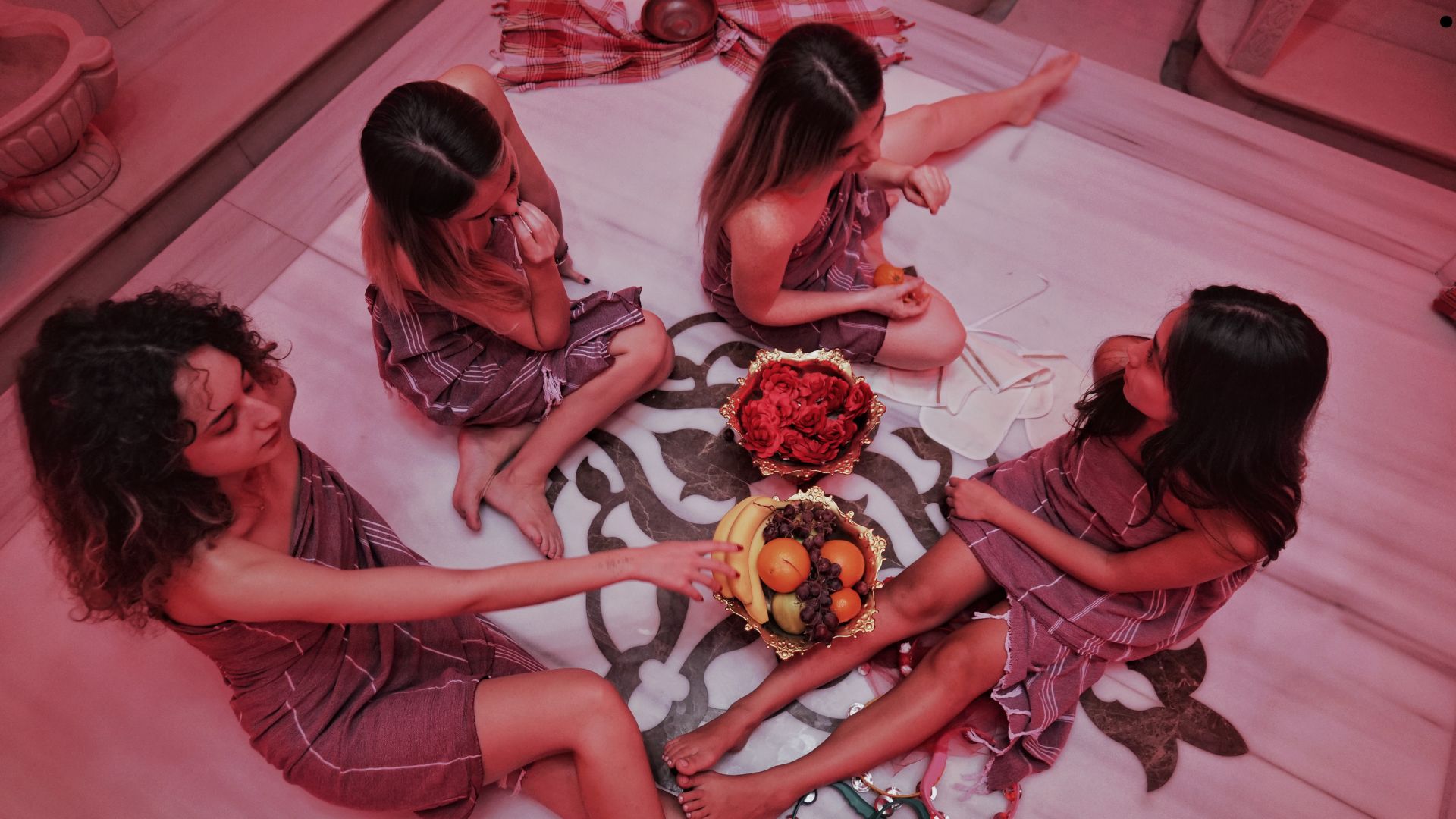 4 girls was sitting and talking each other on hammam