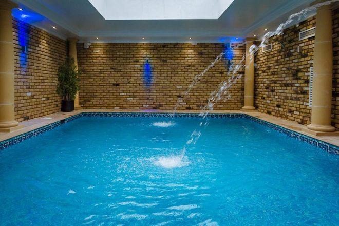 The indoor swimming pool at Old Hammam & Spa, with water jets and brick walls